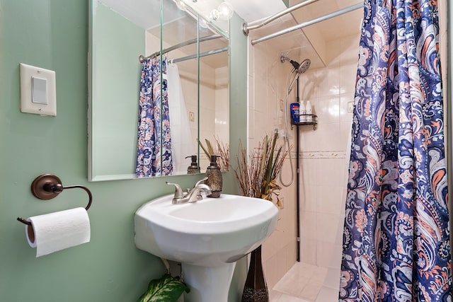 bathroom featuring curtained shower and tile patterned floors