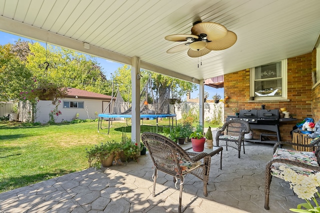 view of patio with ceiling fan, a trampoline, and an outdoor living space