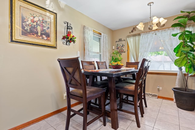 dining space with a notable chandelier and light tile patterned floors