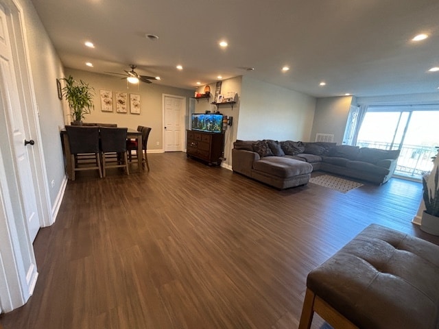 living room with ceiling fan and dark hardwood / wood-style floors