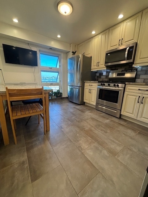 kitchen with appliances with stainless steel finishes and backsplash