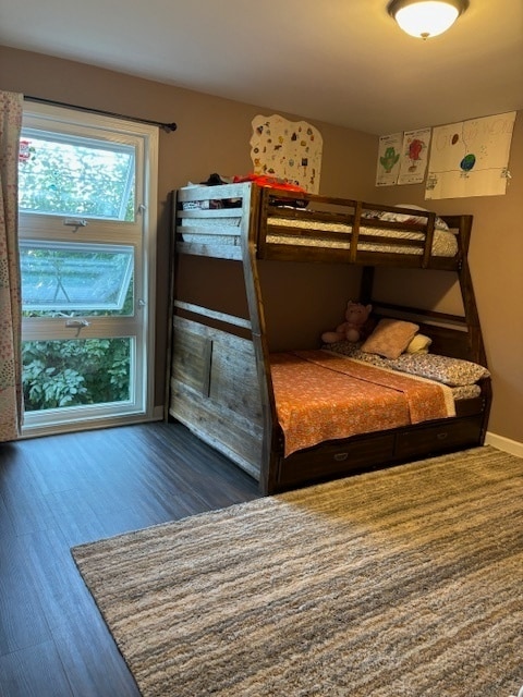 bedroom with dark hardwood / wood-style flooring