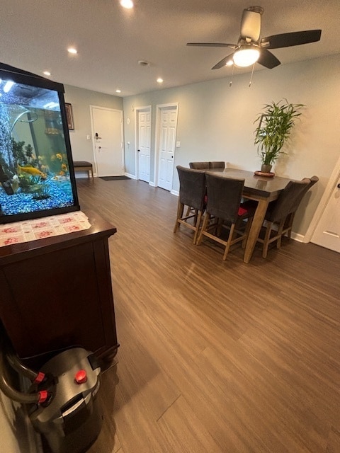 dining space with ceiling fan and hardwood / wood-style flooring