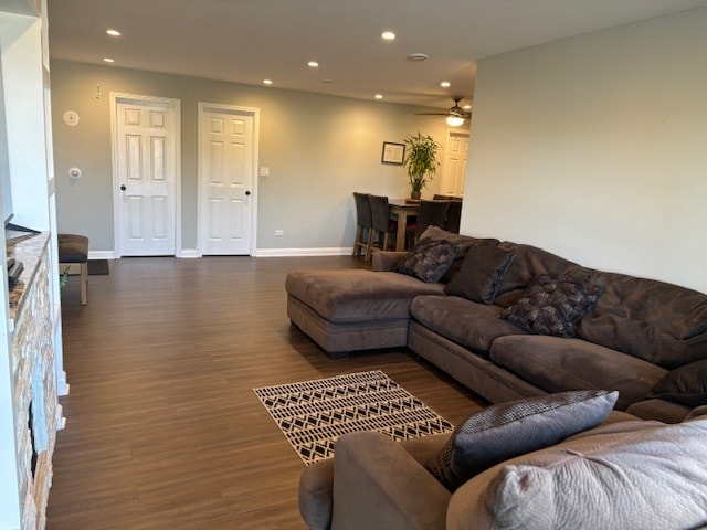 living room featuring dark hardwood / wood-style flooring and ceiling fan