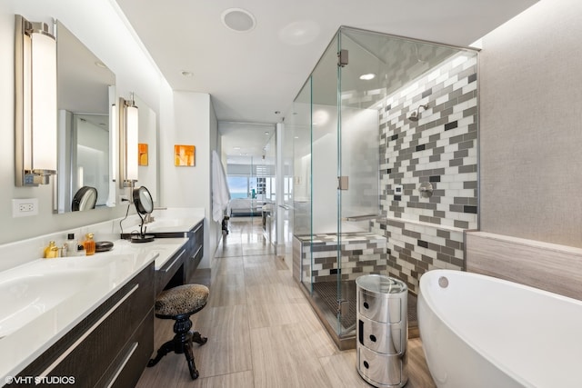 bathroom with vanity, shower with separate bathtub, and tile walls