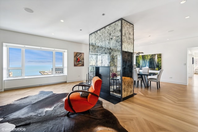 living room with light parquet flooring and a water view