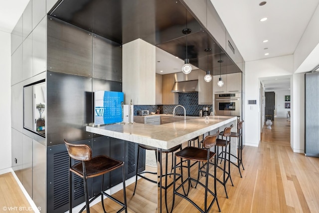 800 N Michigan Ave Unit 4001, Chicago, IL 60611 - kitchen with stainless steel oven, modern cabinets, light wood-style flooring, and recessed lighting
