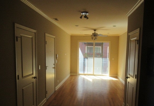 hall with crown molding and hardwood / wood-style floors