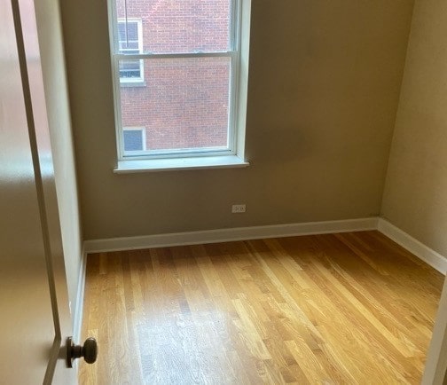 empty room with light hardwood / wood-style flooring