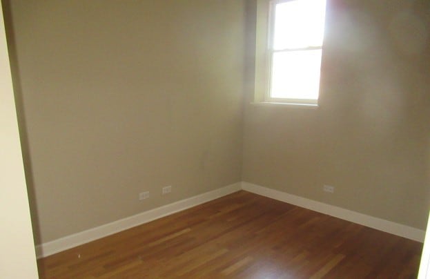 empty room featuring dark wood-type flooring