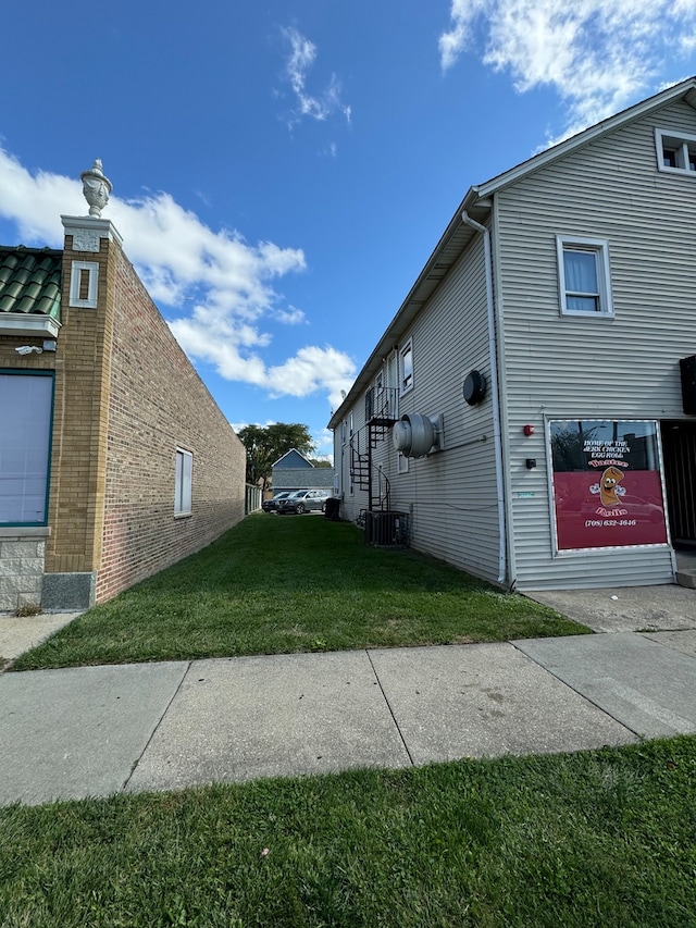 view of property exterior with a lawn