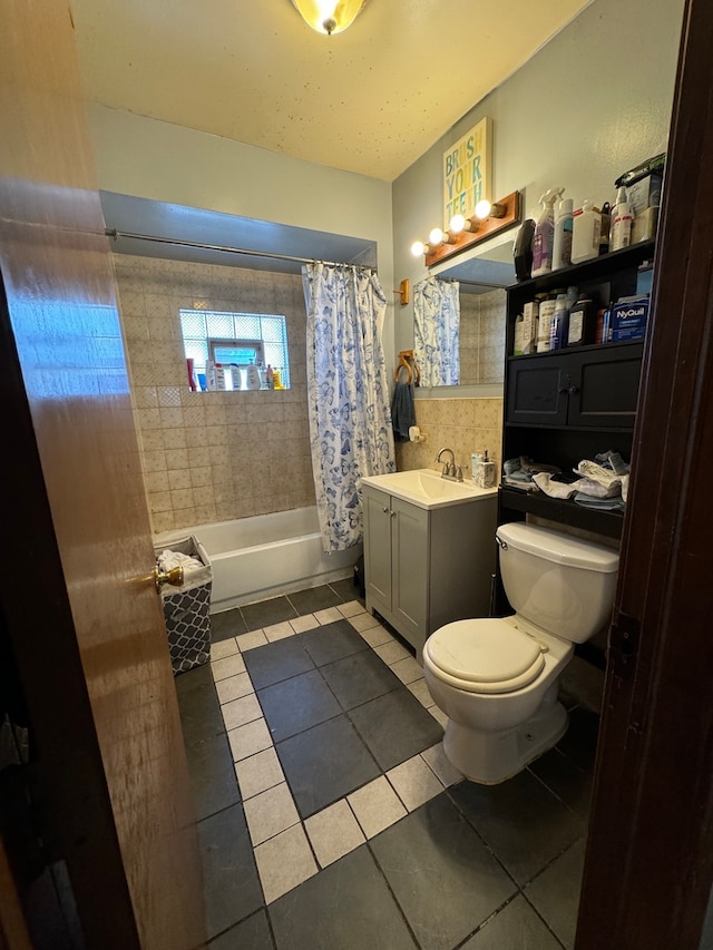 full bathroom featuring shower / bath combo with shower curtain, vanity, tile patterned flooring, and toilet