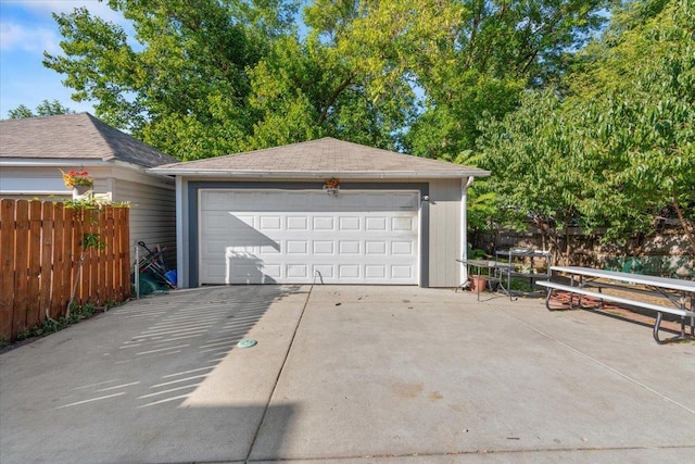 detached garage featuring fence