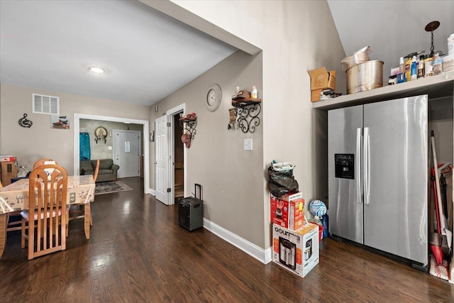 dining room with wood finished floors, baseboards, and visible vents