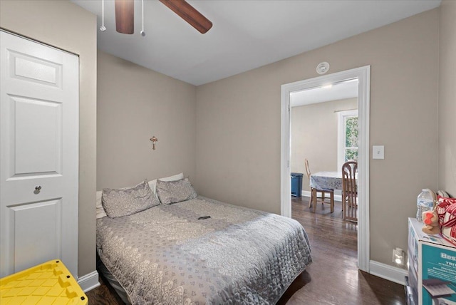 bedroom featuring baseboards and dark wood finished floors