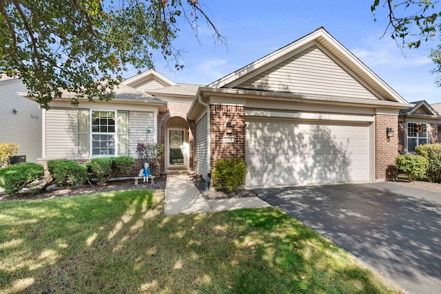 single story home with a front yard and a garage