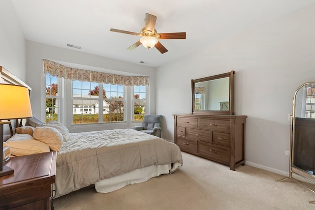 bedroom with ceiling fan and light colored carpet