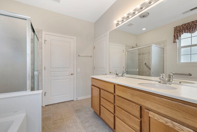 bathroom featuring vanity and shower with separate bathtub