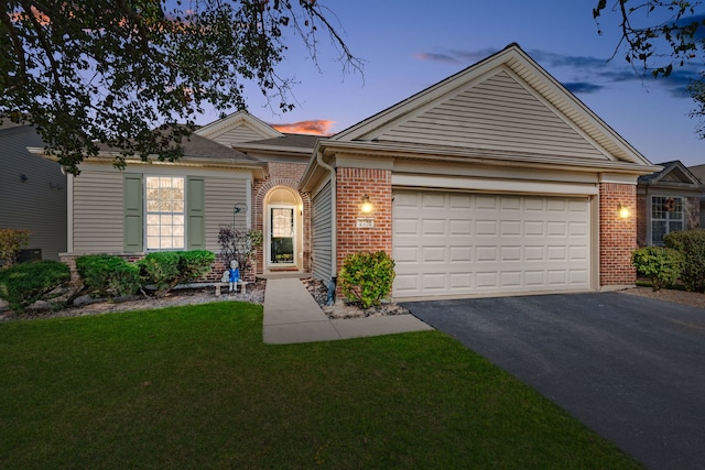 ranch-style house with a lawn and a garage