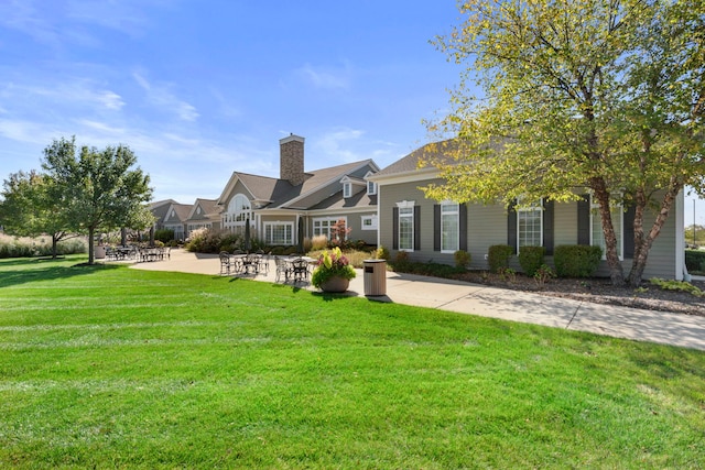 view of front facade with a patio and a front yard