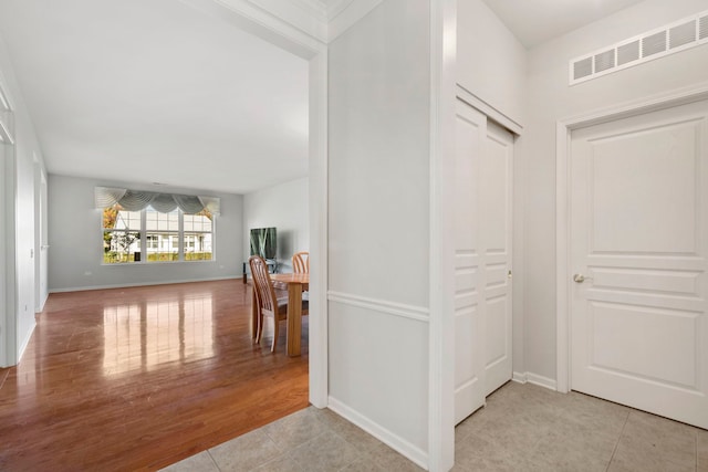 hallway with light hardwood / wood-style floors