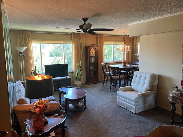 carpeted living room featuring a textured ceiling, ceiling fan with notable chandelier, and plenty of natural light