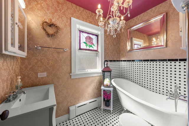 bathroom featuring vanity, a baseboard radiator, a tub to relax in, and toilet