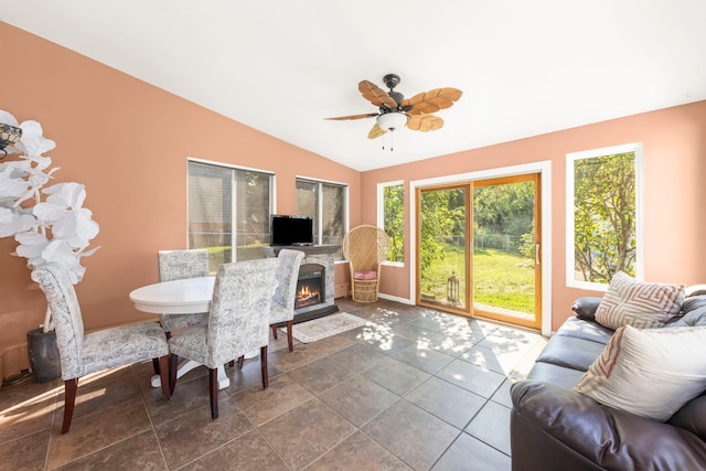 interior space featuring ceiling fan, a fireplace, and lofted ceiling