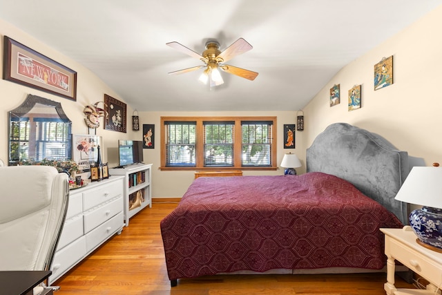 bedroom with lofted ceiling, ceiling fan, and light hardwood / wood-style flooring