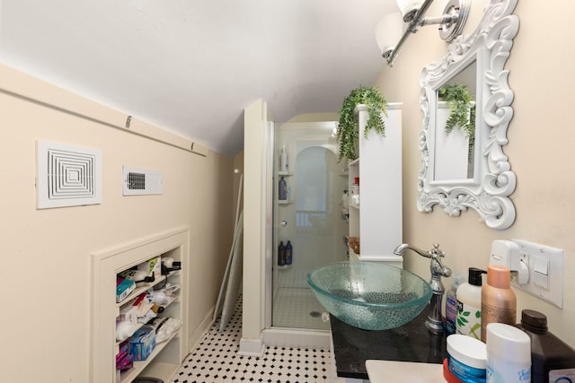 bathroom with vanity and a shower with shower door