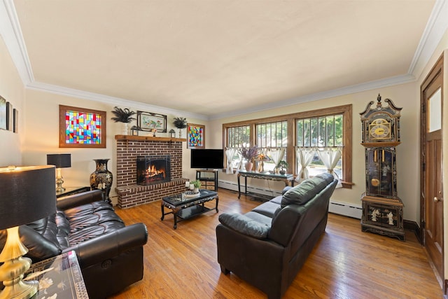 living room featuring a fireplace, ornamental molding, a baseboard heating unit, and hardwood / wood-style flooring