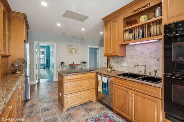 kitchen featuring light stone counters, decorative backsplash, sink, kitchen peninsula, and appliances with stainless steel finishes