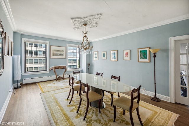 dining room featuring a notable chandelier, ornamental molding, a baseboard radiator, and dark wood-type flooring