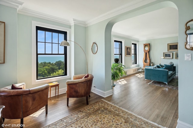 sitting room with hardwood / wood-style flooring and ornamental molding