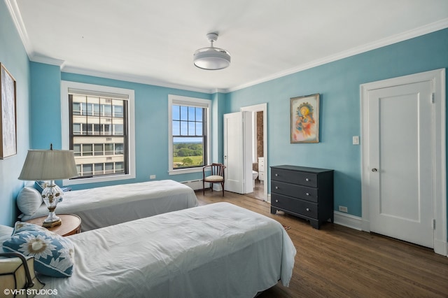 bedroom with dark wood-type flooring, ornamental molding, and baseboard heating