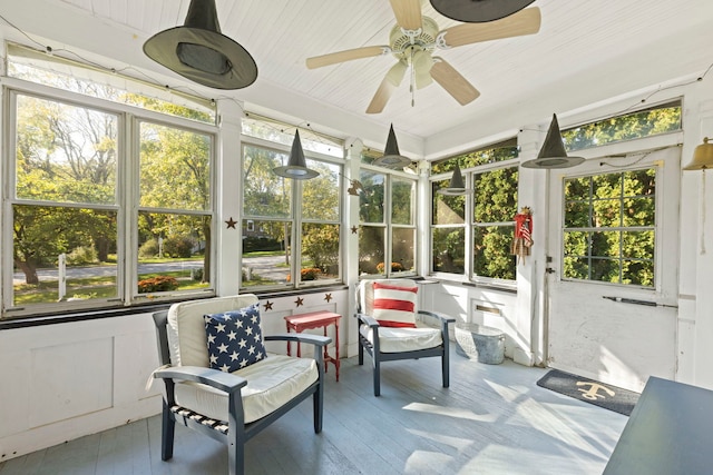 sunroom featuring ceiling fan and a wealth of natural light