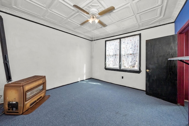 carpeted empty room with heating unit, coffered ceiling, and ceiling fan