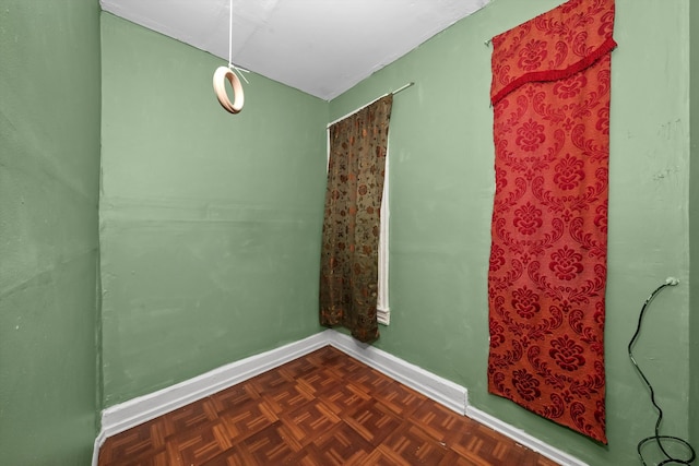 unfurnished room featuring dark parquet flooring