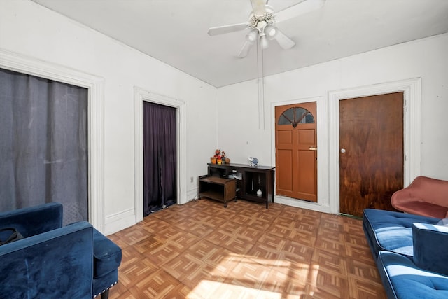 living room with ceiling fan and parquet flooring