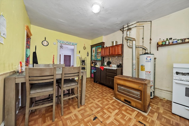 kitchen with water heater, white gas range oven, light parquet floors, and tasteful backsplash