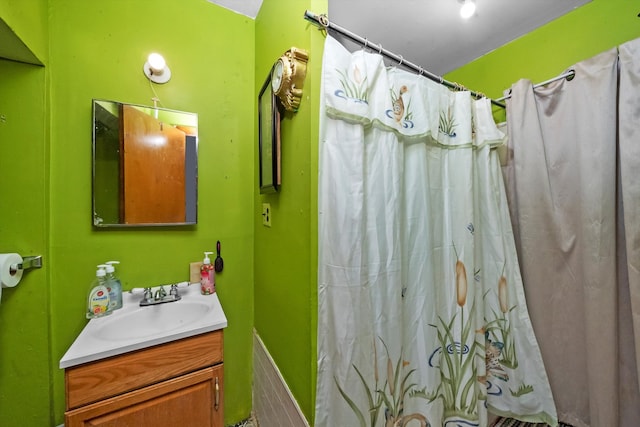 bathroom featuring walk in shower and vanity