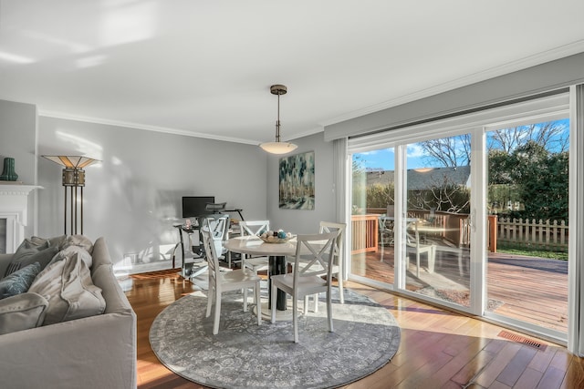 dining room featuring hardwood / wood-style flooring and ornamental molding