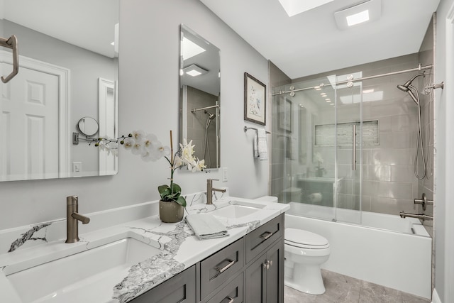 full bathroom featuring tile patterned flooring, vanity, toilet, and bath / shower combo with glass door