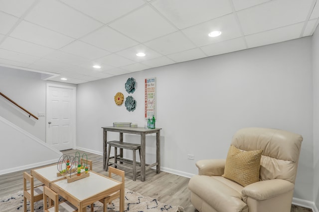 sitting room with a paneled ceiling and light hardwood / wood-style floors