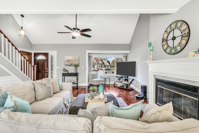 living room with ceiling fan, hardwood / wood-style floors, and vaulted ceiling