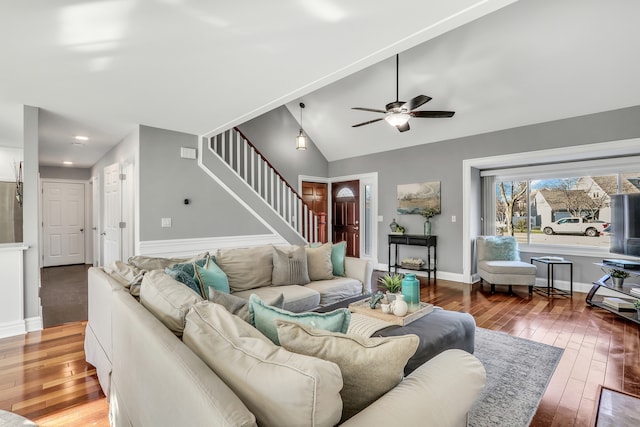 living room with wood-type flooring, vaulted ceiling, and ceiling fan