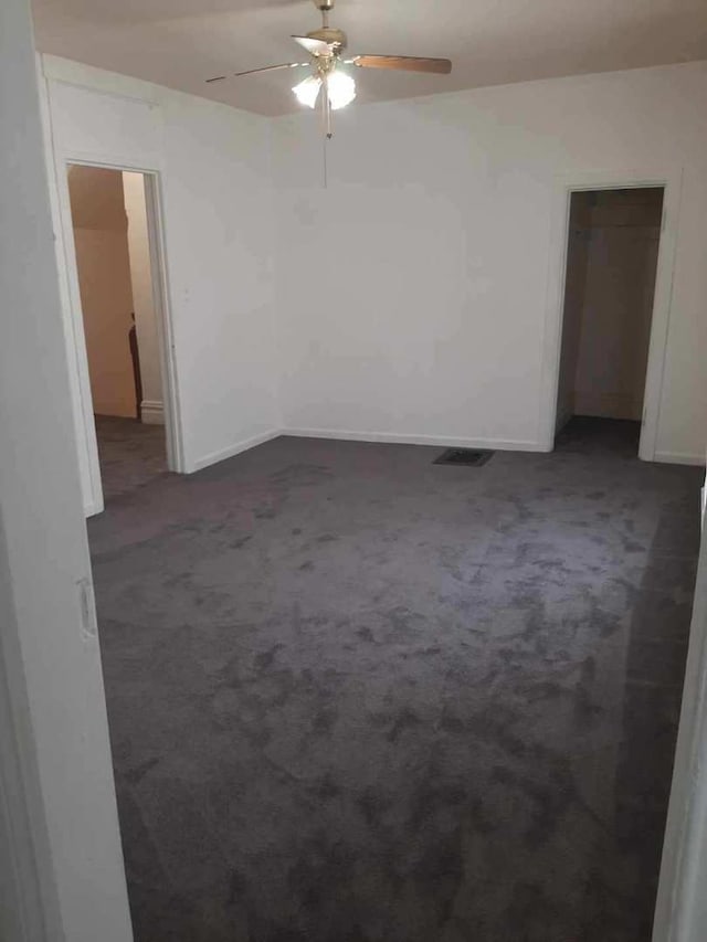 109 E Chamberlin St, Dixon, IL 61021 - unfurnished room with dark carpet, a ceiling fan, and baseboards