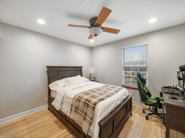 bedroom with light hardwood / wood-style floors and ceiling fan