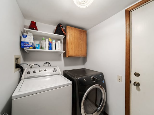 washroom featuring cabinets and washer and dryer