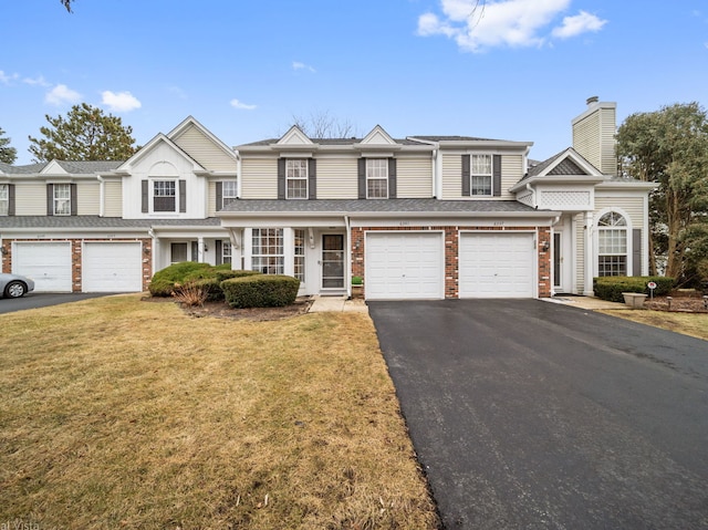 view of front of home with a garage and a front yard